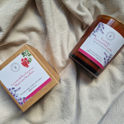 A Lavender candle on a sheet with outer packaging alongside