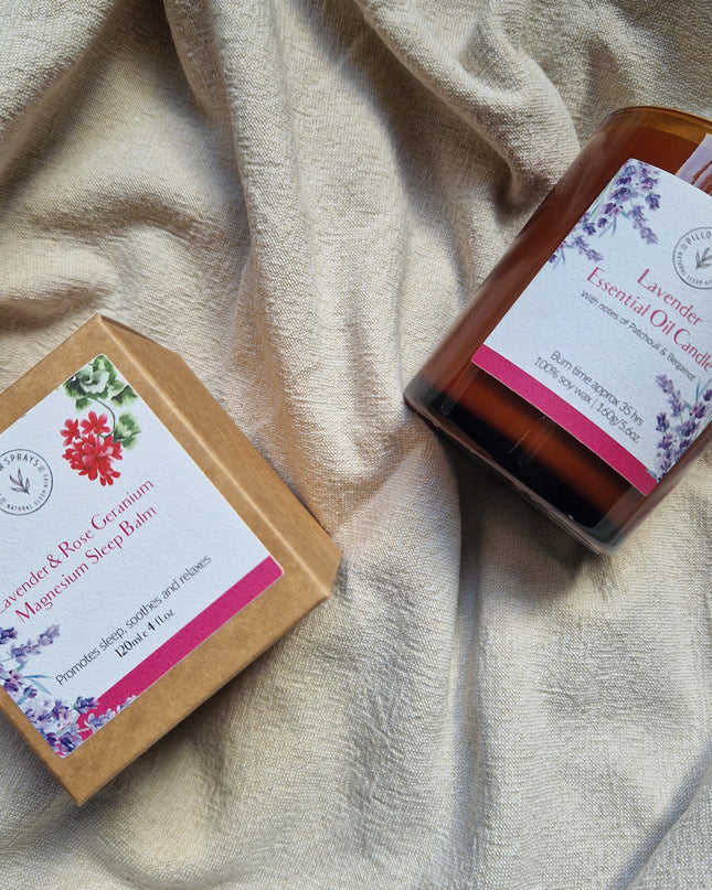 A Lavender candle on a sheet with outer packaging alongside