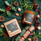 A candle in an amber glass jar on a wintery background