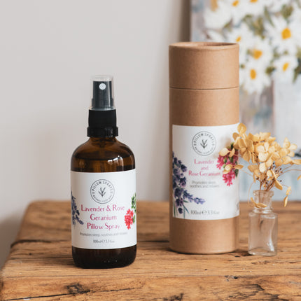 A Lavender and Rose Geranium Pillow Spray on a bedside table