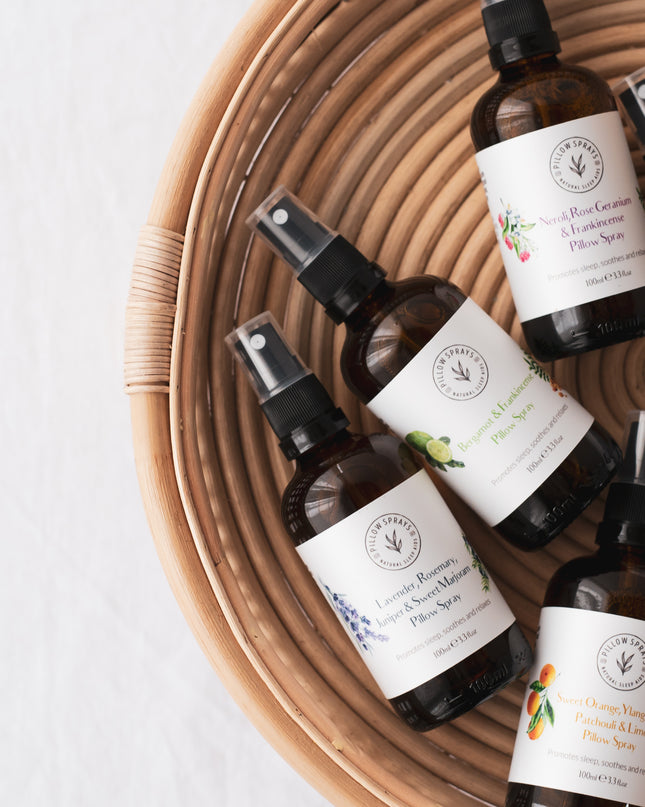 A set of 6 Pillow sprays in a basket
