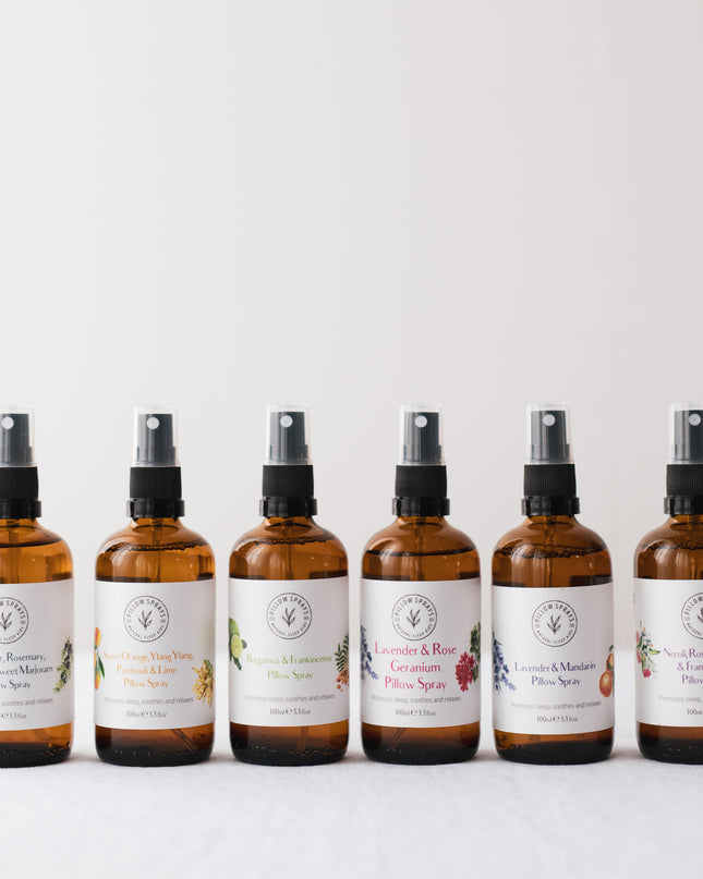 A set of 6 pillow sprays arranged in a line all different scents