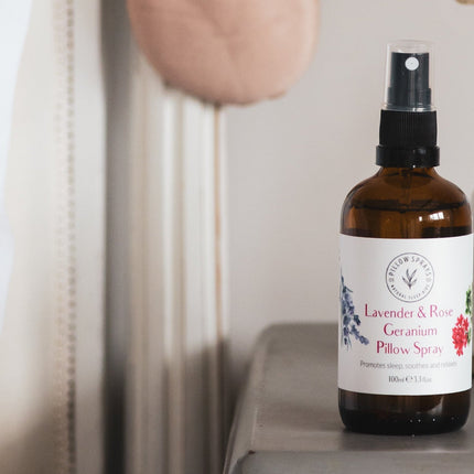Pillow spray bottle on a surface with a neutral background